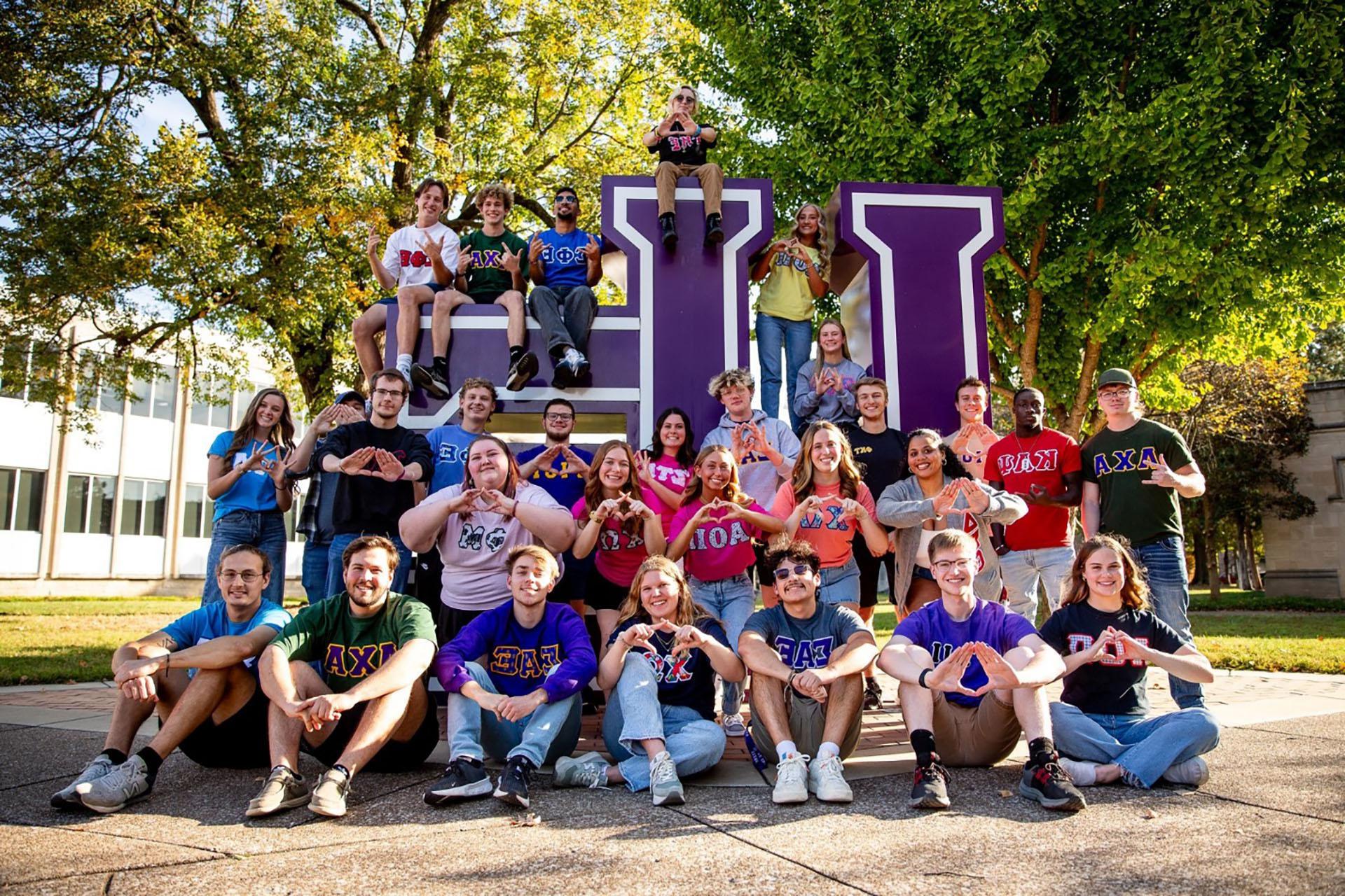 Greek Life students in front of the UE letters